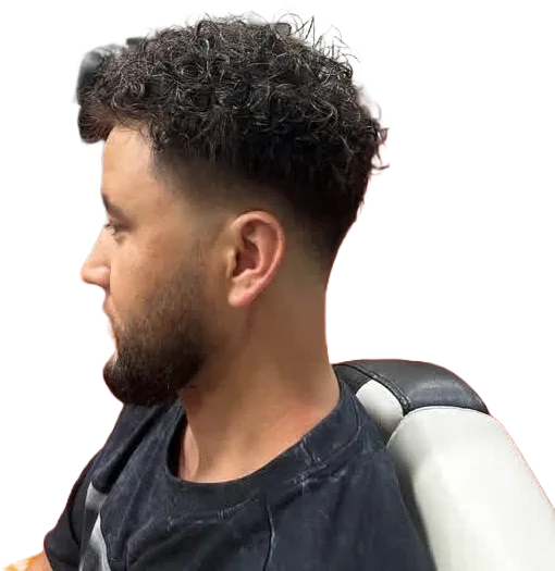 Curly top with a low taper fade by Mr. P