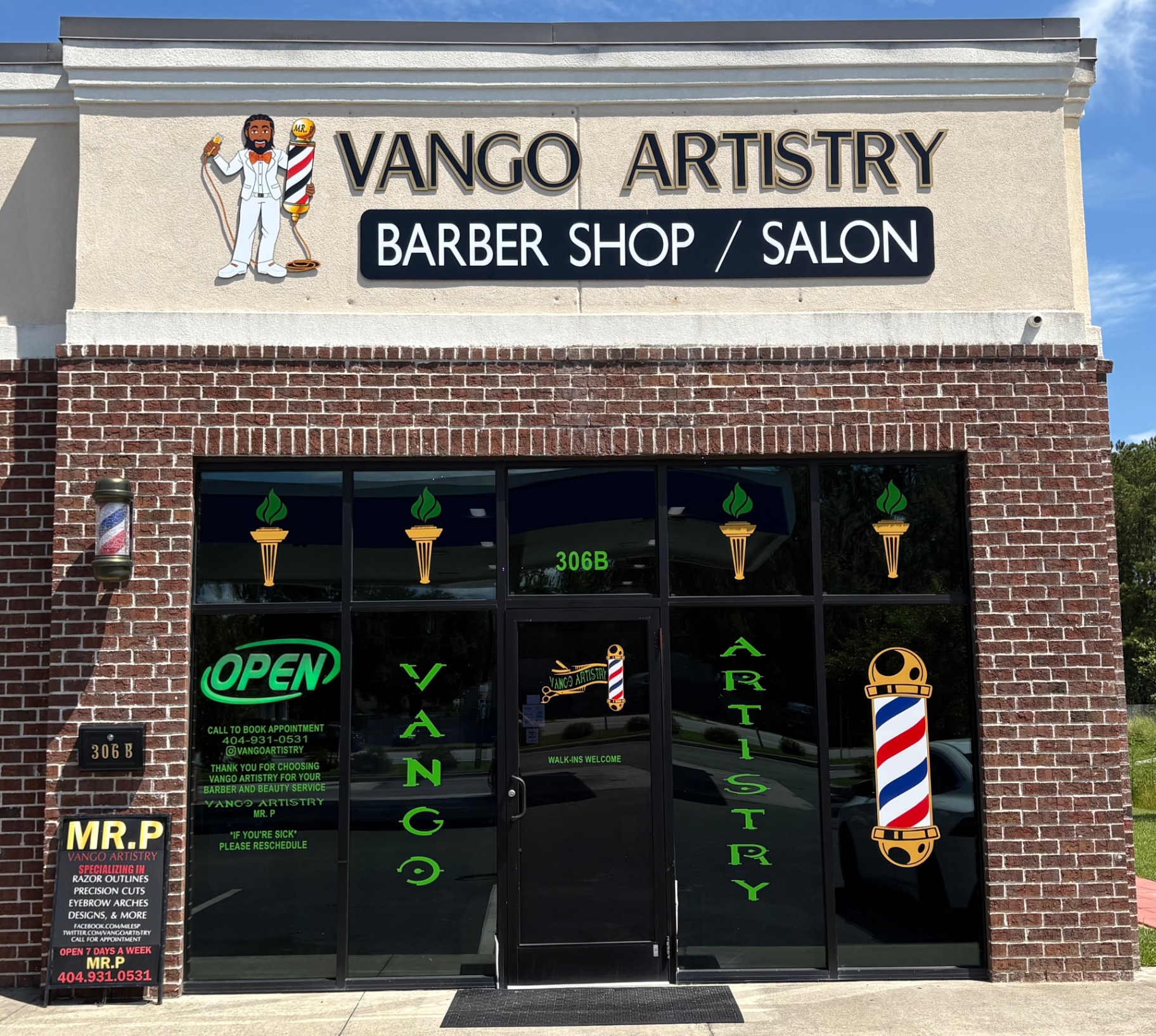 Brick storefront of the barber shop on US-80 in Bloomingdale with an open sign