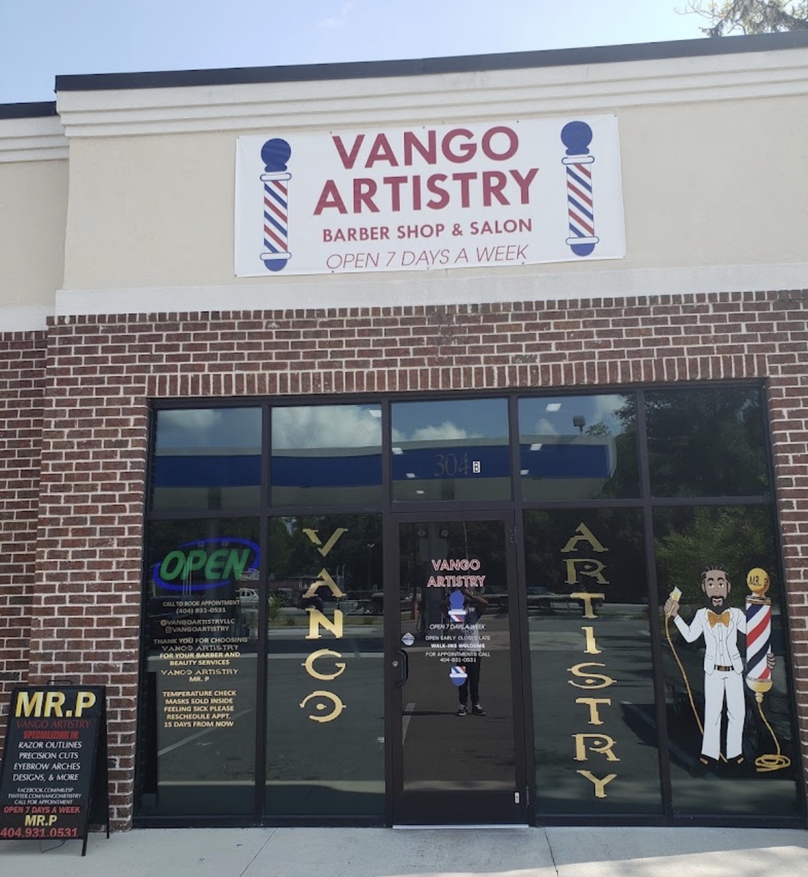 Brick storefront of the barber shop on US-80 in Bloomingdale with an open sign